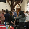 Group of New Faculty Members discussing together in Shusterman Hall